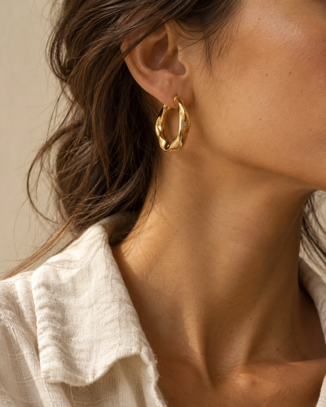 Detalhe editorial de uma argola dourada em uso
